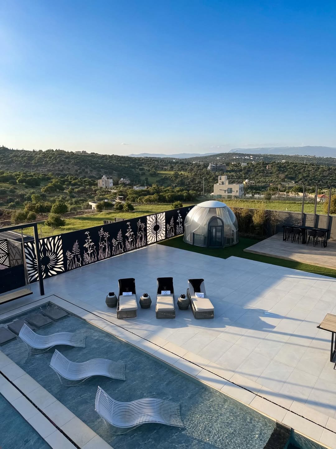 Scenic terrace with infinity pool and lounge chairs