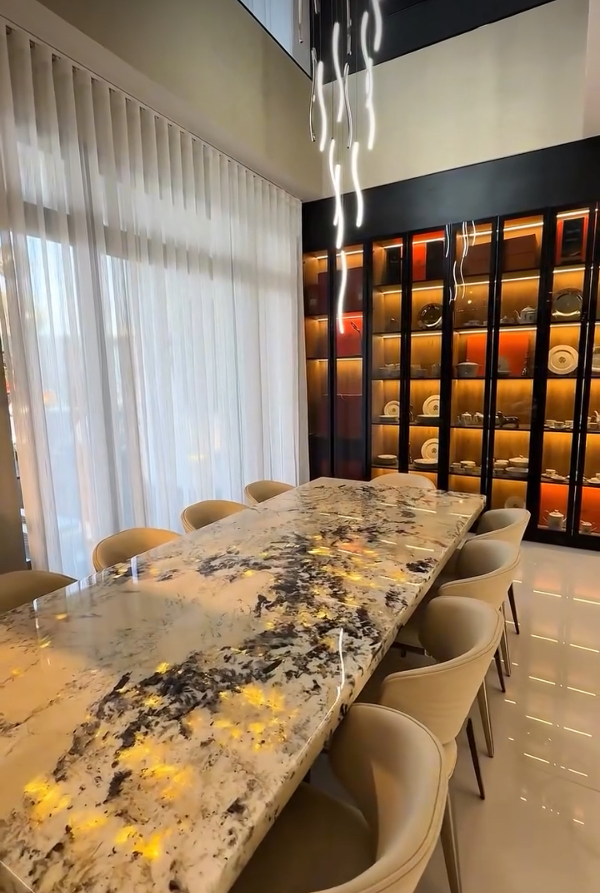 Signature dining room with marble table and display cabinetry